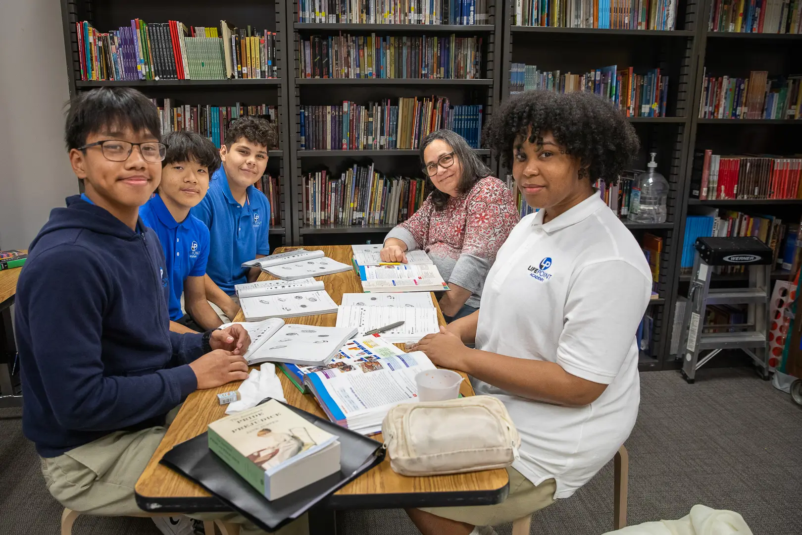 LifePoint Academy students and staff working together at a table