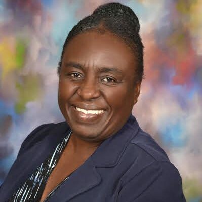 Black woman smiling at the camera.